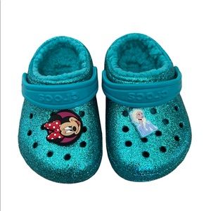 Teal sparkly crocs with Minnie Mouse and Elsa